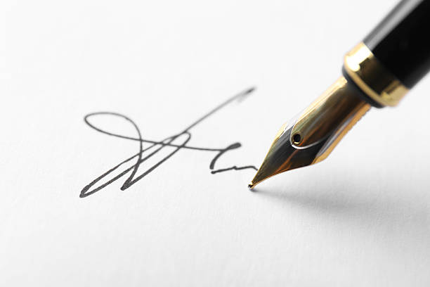 istock Fountain pen leaving signature on paper, closeup 2252014581