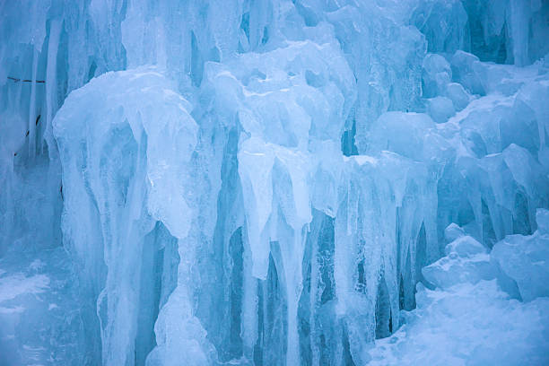istock Ice formations on frozen waterfall with textured icicles and solid blue surfaces winter nature detail cold climate 2252015181
