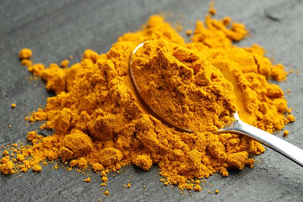 istock Turmeric powder and spoon on grey table, closeup 2252015208