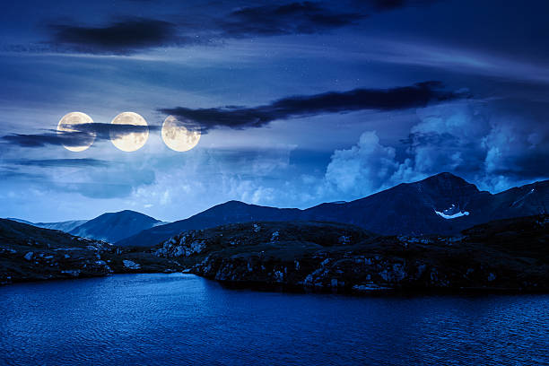 istock serene alpine lake among green hills at night 2252016269