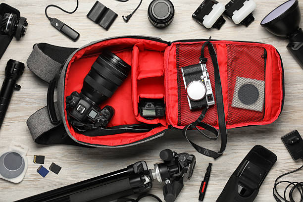 istock Professional photographer's equipment and backpack on light wooden background, flat lay 2252016877