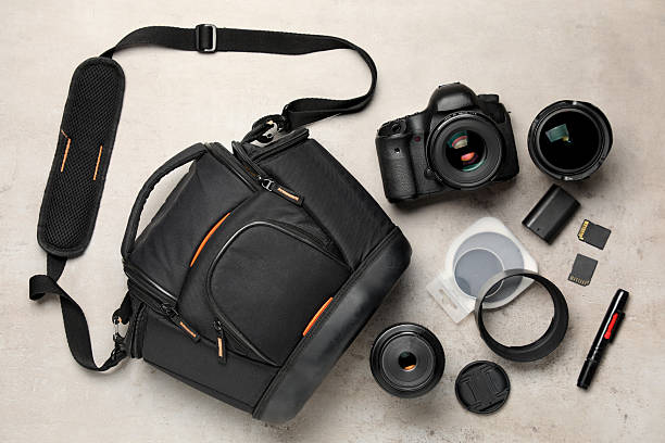 istock Professional photographer's equipment and case on light background, flat lay 2252016884