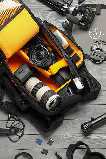 istock Professional photographer's equipment and backpack on grey wooden background, flat lay 2252017186