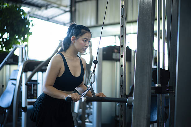 istock Focused young woman training triceps with cable machine in a modern gym, showing strength 2252017664