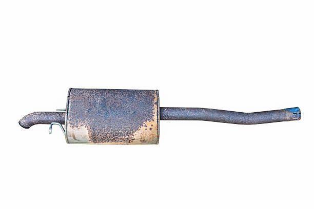 Used, rusted car exhaust muffler with attached tailpipe and mounting bracket, isolated on a white background, no people