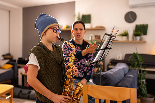 istock Young Saxophonist Practicing With Teacher In Cozy Home Studio 2252018519