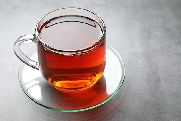 istock Refreshing black tea in cup on grey textured table, closeup. Space for text 2252018900