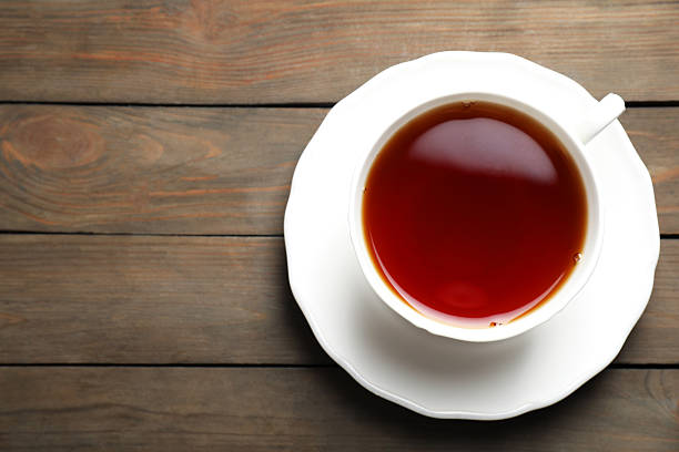 istock Refreshing black tea in cup on wooden table, top view. Space for text 2252019346
