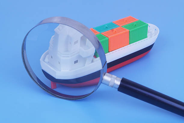 A close-up view of a cargo ship loaded with colorful stacked shipping containers, docked near calm waters. This image captures the essence of international trade, maritime logistics, and the global shipping industry.