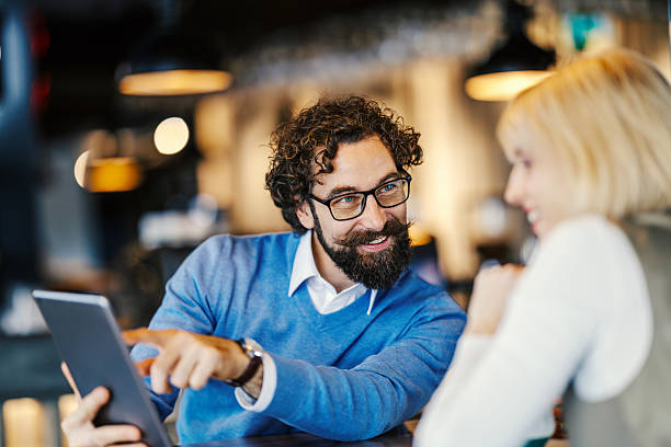 istock Business colleagues having meeting, using tablet in cafe 2252028313