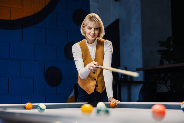 istock Woman smiling playing billiards enjoying leisure activity 2252028824