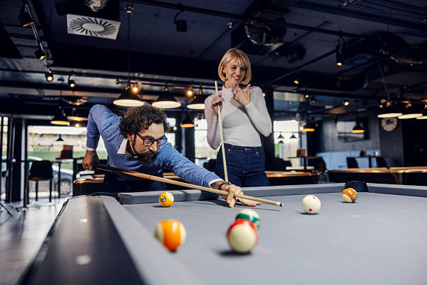 istock Couple playing pool on a date in bar 2252029118