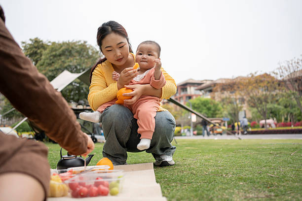 Mother camping outdoors with baby