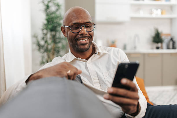istock Happy man enjoying smartphone in cozy setting 2252030410
