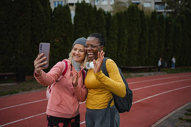 istock Diverse women taking selfie for video call on running track 2252030802