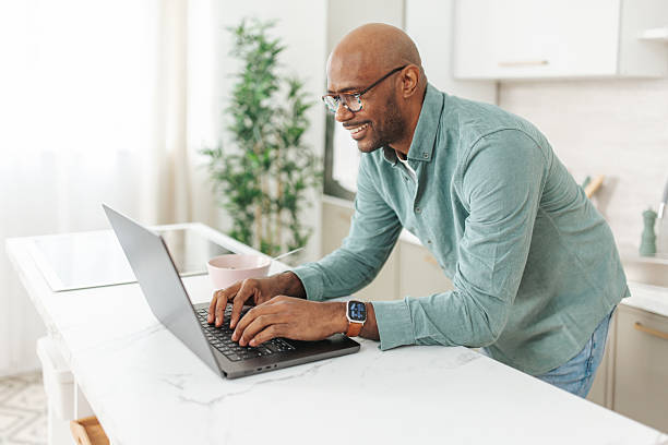 istock Focused man working on laptop in cozy kitchen 2252032043