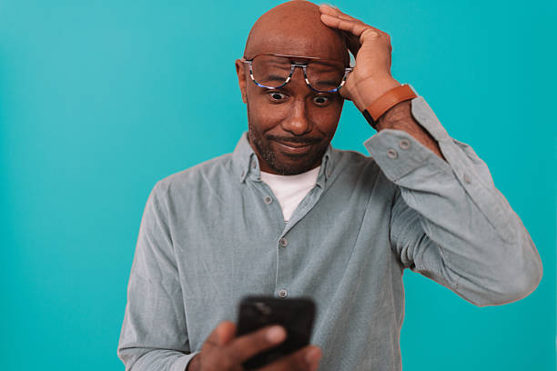 istock Man Looking Stunned While Holding His Phone 2252032534