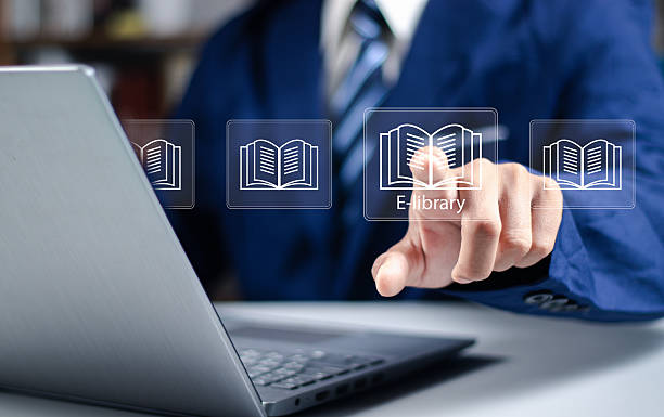 istock E-library concept. Woman use smartphone and hand touch with virtual Ebook icons for electronic books online, knowledge base on internet, digital library or e-library. 2252036013