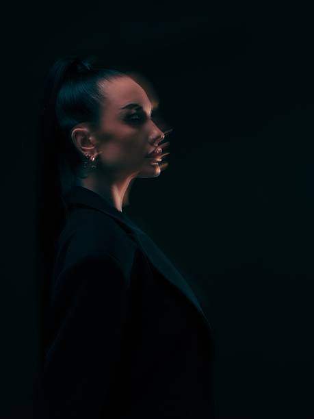 Cinematic side-profile portrait of woman emerging from darkness, with subtle motion blur and soft rim light. Abstract technology, innovation, and futuristic concept. Double exposure.