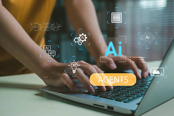 istock Hands typing on a laptop with glowing AI agent icons, representing automation, data processing, machine learning, and digital innovation for modern business and technology solutions. 2252038374