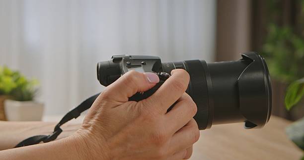 istock Close Up of a Hand Holding a Camera with Lens 2252038686