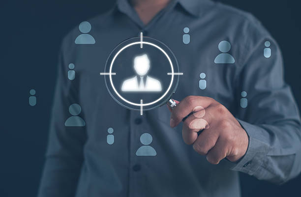 istock person holding a magnifying glass focusing on target user icon, representing customer targeting, audience analysis, recruitment selection, and data-driven strategies for identifying ideal candidates. 2252038864