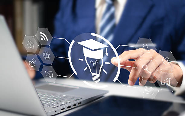 istock E-learning and online education technology concept. Internet lessons and online webinar, enhanced learning with personalized courses. Man use laptop with E-learning icon. 2252040392