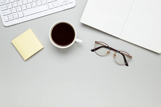 istock Cozy workspace with coffee cup, keyboard, glasses and notebook creating focused morning atmosphere 2252042698