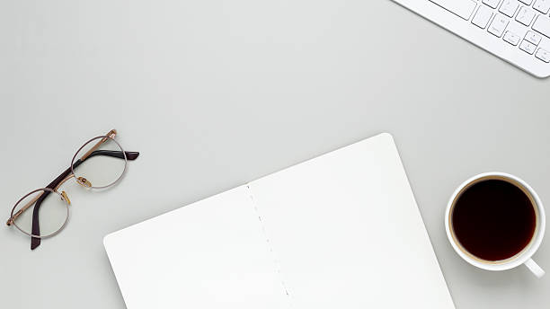 istock Comfortable workspace featuring coffee, keyboard, glasses and notebook for a productive morning mood 2252042717