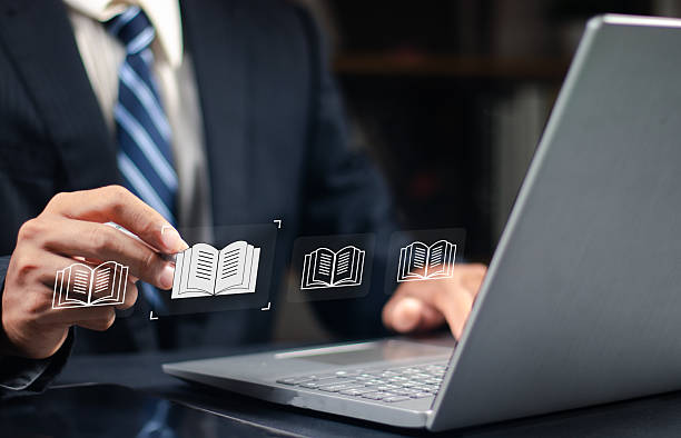 istock E-library and E-learning Concept, Person using laptop with virtual E-Book icons for online knowledge Base, Digital library, Access electronic books on Internet. Course education. Webinar technology. 2252044648