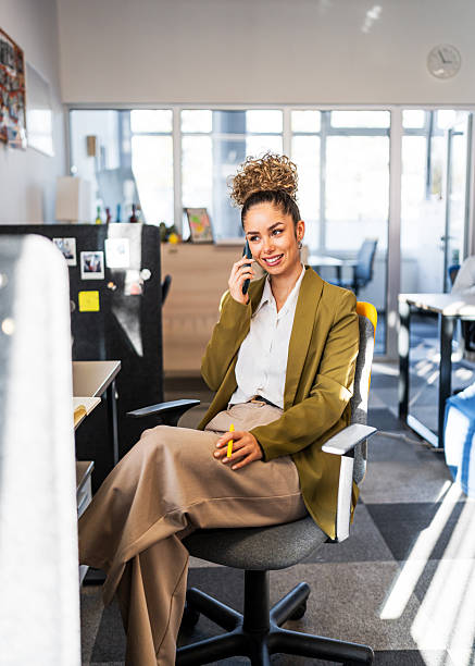 istock Confident businesswoman talking on phone in office 2252048584