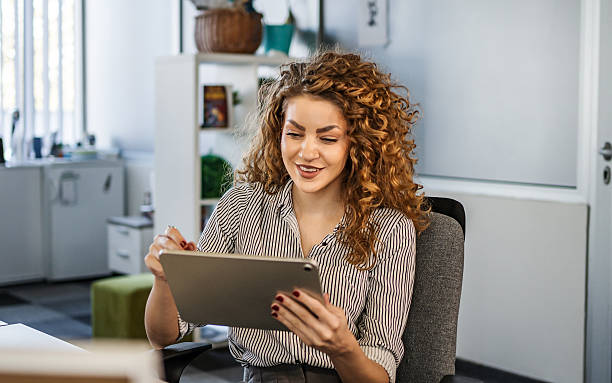 istock Confident young businesswoman working on tablet in office 2252048634
