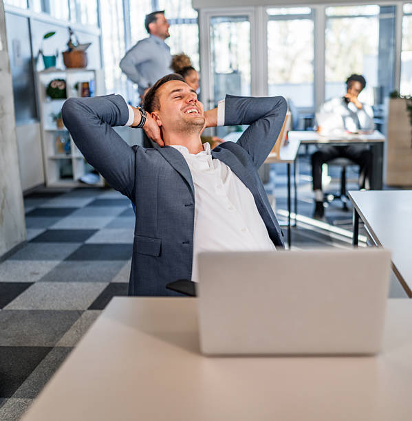 istock Happy businessman relaxing after successful work in office 2252049129