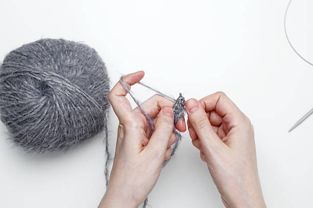 istock Woman knitting with needles creating handmade fabric 2252049205