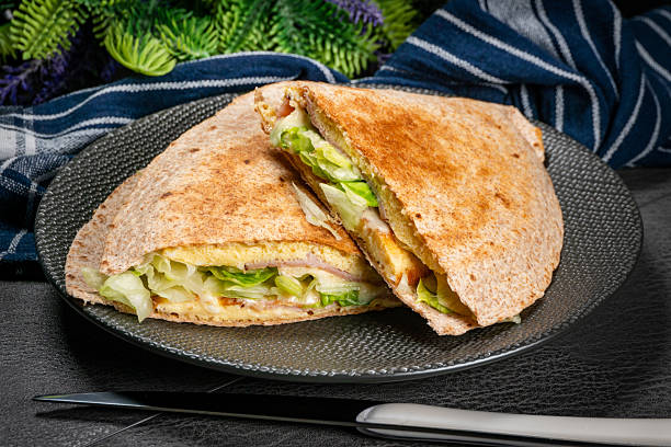 istock Tortilla multigrain with omelette, lettuce and ham. 2252049888