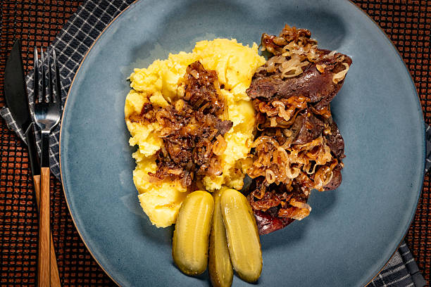 Mopane worms come from the mopane tree and feed on their leaves. They are an important source of protein in South African culture and treated as a delicacy, seen here served with maize meal and tomatoes.
