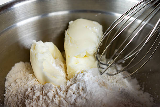 istock Solid vegetable shortening is cut into the dry flour mixture in a silver bowl using a whisk, a key step for making light and fluffy waffles in Waukesha County. 2252051351