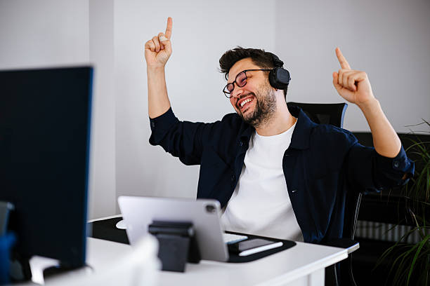 istock Excited young man looking at laptop celebrating online victory 2252052729