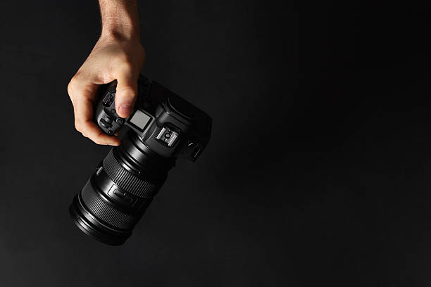 istock Photographer with professional camera on black background, top view. Space for text 2252053462