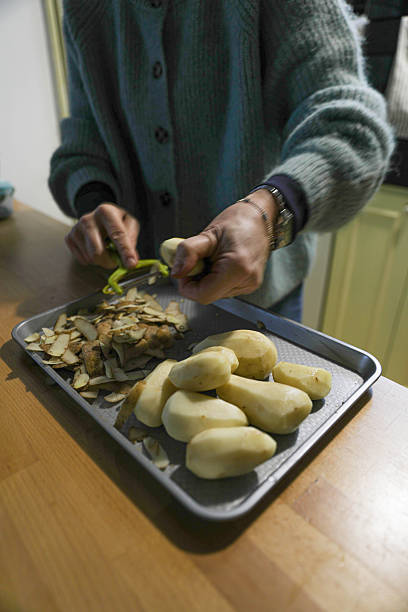 istock Close-Up Of Hands Preparing Fresh Potatoes In The Kitchen 2252054168