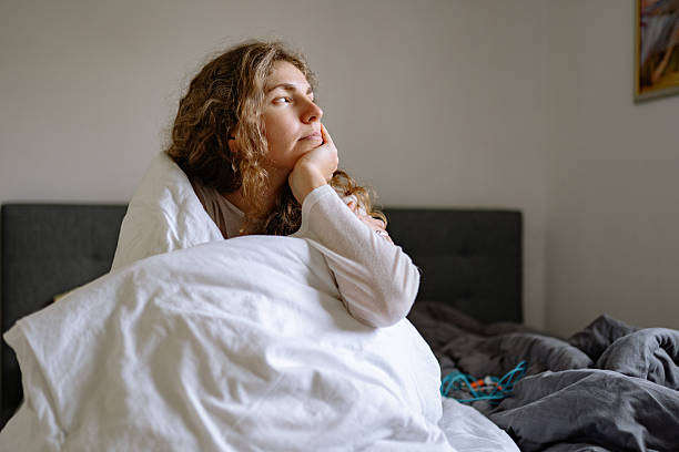 istock Mother in bed hugging child on quiet cozy morning 2252054887