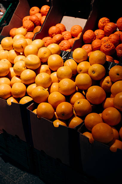 istock Fresh oranges and tangerines neatly arranged in boxes for sale. 2252054940