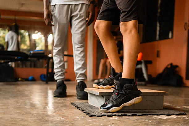 istock Coach training young boy in gym step aerobics 2252057262