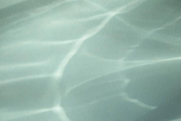 Abstract sunlight shadows blue background with flare and glare. Natural abstract aesthetic mockup with caustic effects for design and modern presentation.
