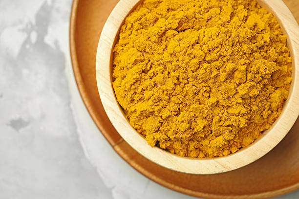 istock Turmeric powder in bowl on light grey table, top view 2252058001