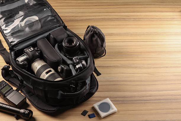 istock Professional photographer's equipment and backpack on wooden table. Space for text 2252058363
