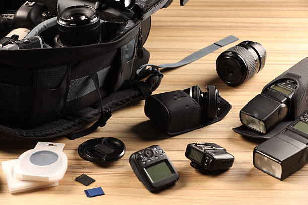 istock Professional photographer's equipment and backpack on wooden table 2252058365