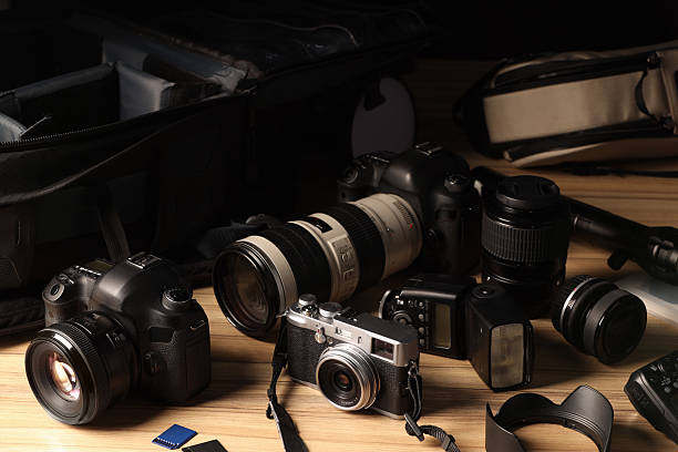 istock Professional photographer's equipment and backpack on wooden table 2252058368