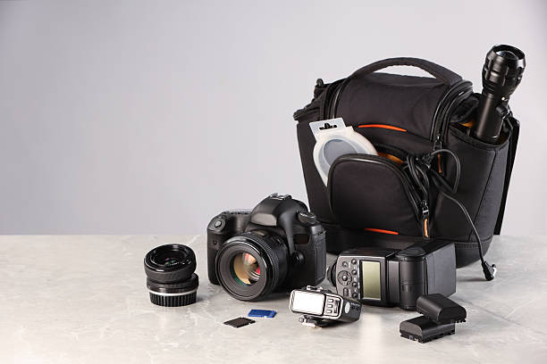 istock Professional photographer's equipment and case on light table. Space for text 2252058418