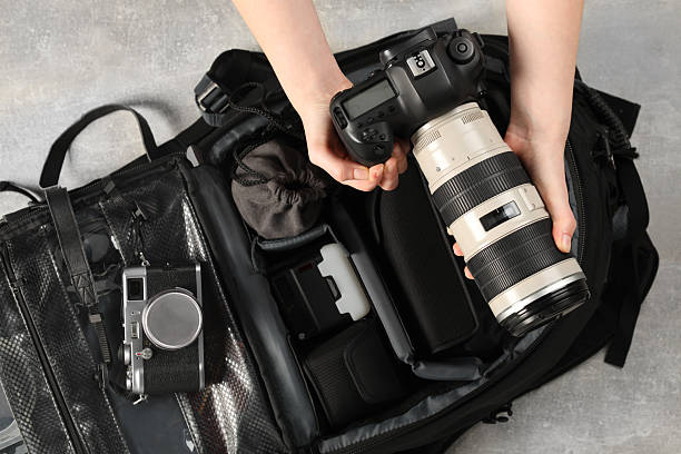 istock Photographer with professional equipment and backpack at light table, top view 2252058419